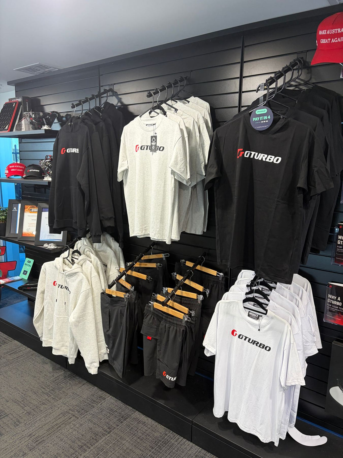 GTURBO branded T-shirts and hoodies produced by Merch Control, on display in a retail store