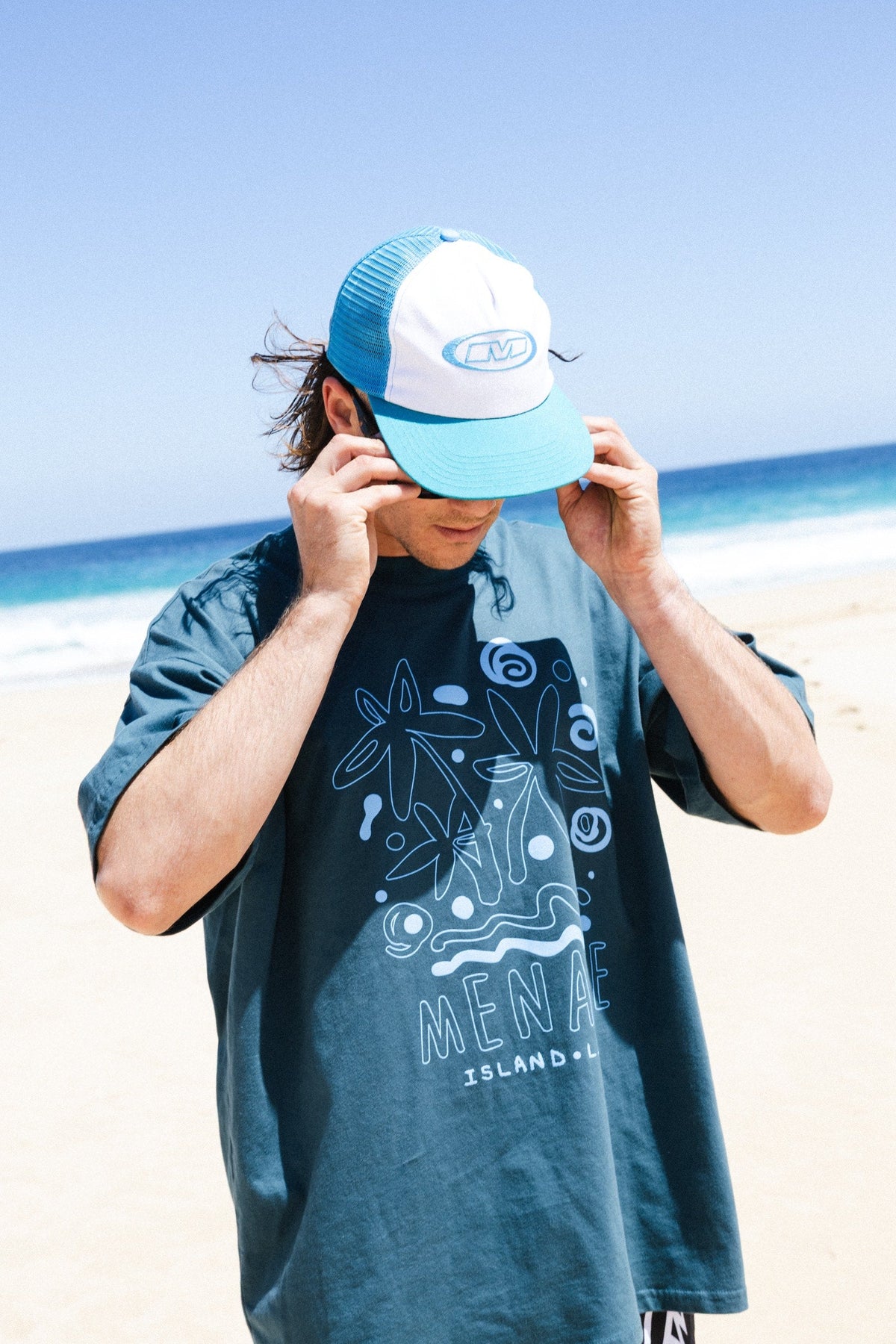 Menace Company Island Life printed tee and mesh cap worn on the beach