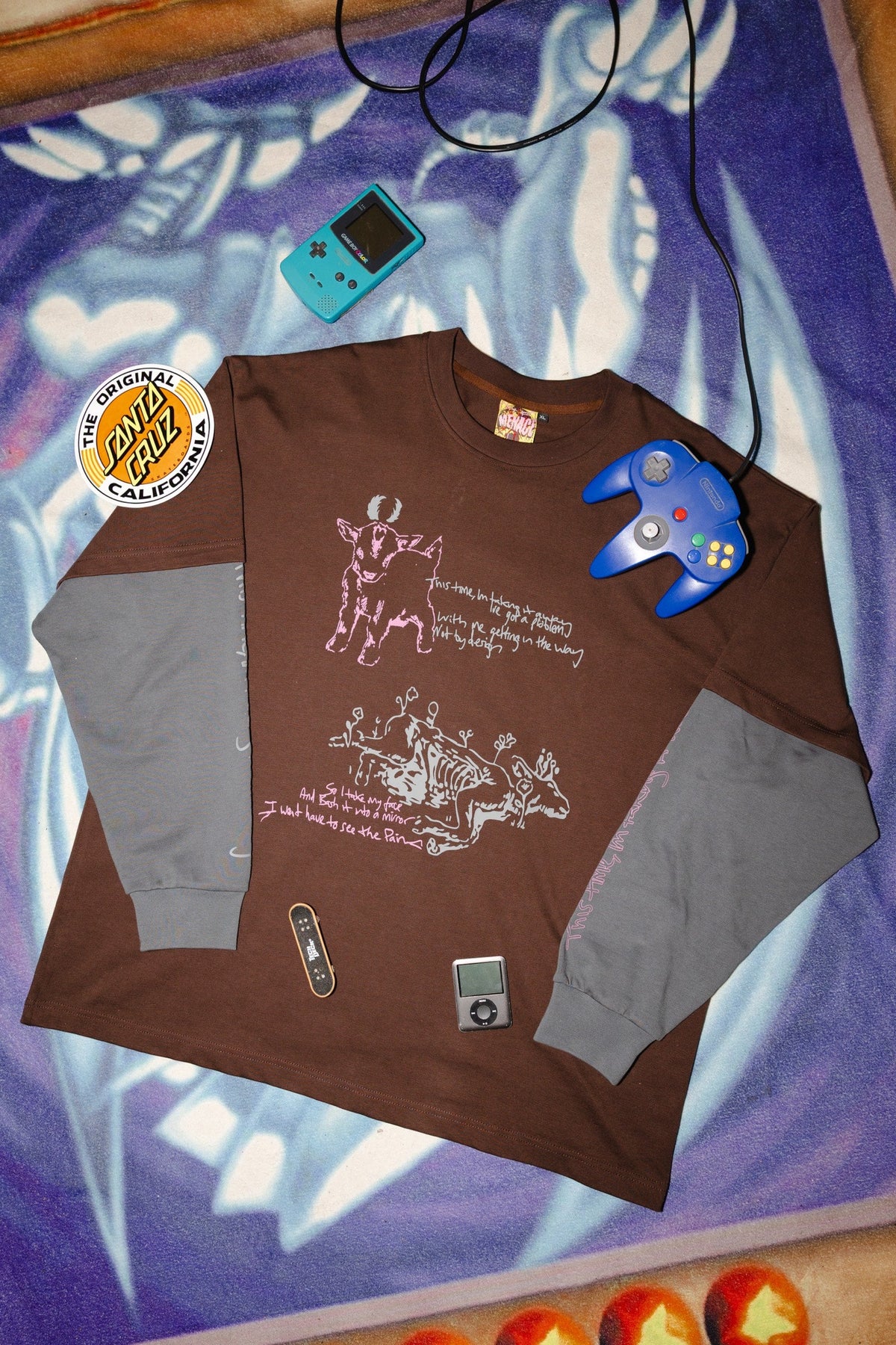 Menace Company printed long sleeve with contrast sleeves, flat laid with retro gaming pieces
